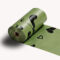Close-up of a single green SmartPawz biodegradable dog waste bag roll showing black paw and heart print patterns.